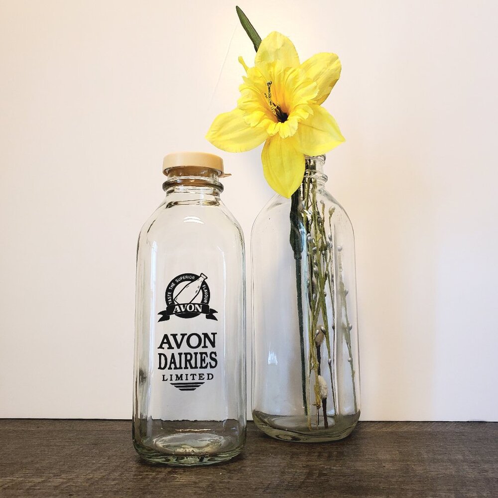 Vintage Milk Bottles. Avon Dairies 9" Clear 10",  3" Base. One Lid.